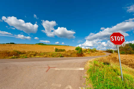 Road Stop Sign before the Intersection in Tuscany, Italyの写真素材