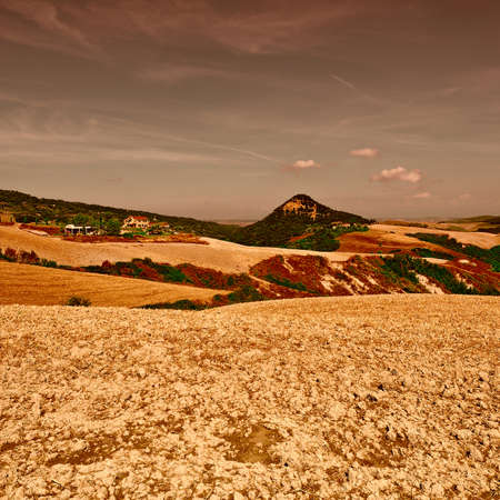 Plowed Sloping Hills of Tuscany in the Autumn at Sunset, Vintage Style Toned Pictureの写真素材