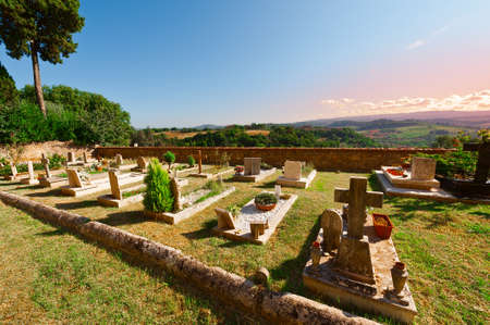 Churchyard on the Background of the Tuscan Landscape at Sunsetの写真素材