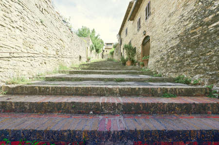 Narrow Alley with Old Buildings in Italian City, Vintage Style Toned Pictureの写真素材