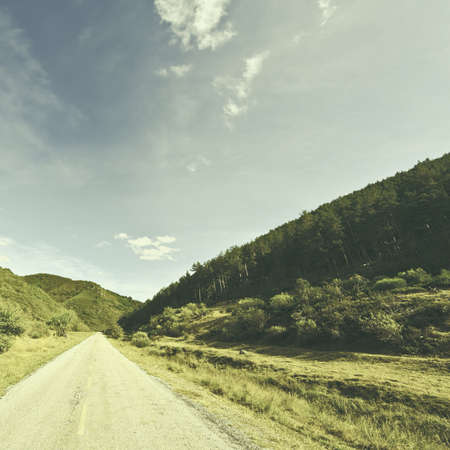Asphalt Road in the Cantabrian Mountain, Spain, Vintage Style Toned Pictureの写真素材