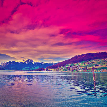 Lake Sarner on the Background of Snow-capped Alps in Switzerland at Sunsetの写真素材