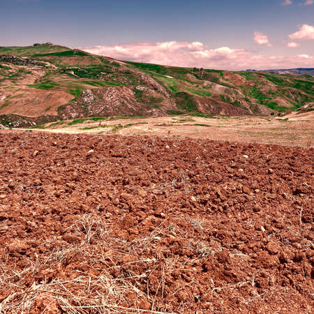 Plowed Sloping Hills of Sicily in the Spring at Sunsetの写真素材