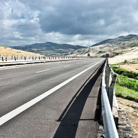 Landscape of Sicily with Highway and Many Hay Bales