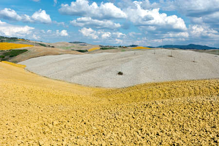 Power Lines on the Plowed Sloping Hills of Tuscany in the Autumnの写真素材