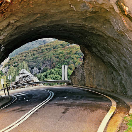 Tunnel on the Winding Asphalt Road in Spain, Vintage Style Toned Pictureの写真素材