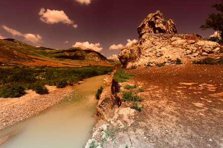 Mountain Stream between the Volcanic Hills of Sicily at Sunsetの写真素材