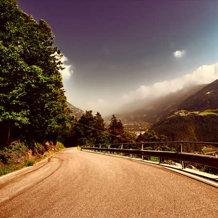 Winding Paved Road in the Italian Alps, Retro Image Filtered Styleの写真素材