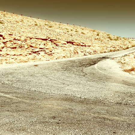 Meandering Road in Sand Hills of Judean Mountains, Israel, Retro Image Filtered Styleの写真素材