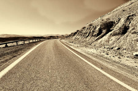 Winding Asphalt Road in the Negev Desert in Israel, Retro Image Filtered Styleの写真素材