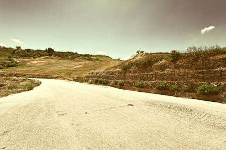 Winding Asphalt Road between Fields of Sicily, Retro Image Filtered Styleの写真素材