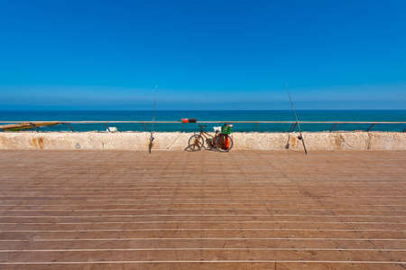 Bicycle and Fishing Rod on the Promenade of the Old Port in Tel Avivの写真素材