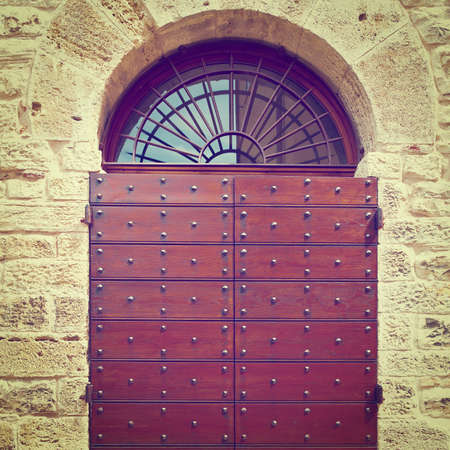 Wooden Ancient Italian Door in Historic Center,の写真素材