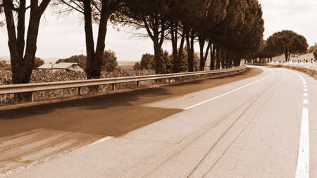 Winding Asphal Road between Fields in Sicily, Vintage Style Sepiaの写真素材
