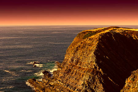 Rocky Coast of Atlantic Ocean in Portugal at Sunsetの写真素材
