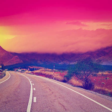 Winding Asphalt Road at Sunset in Spainの写真素材