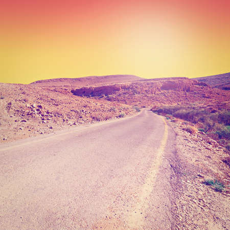 Meandering Road in Sand Hills of Judean Mountains at Sunset,の写真素材