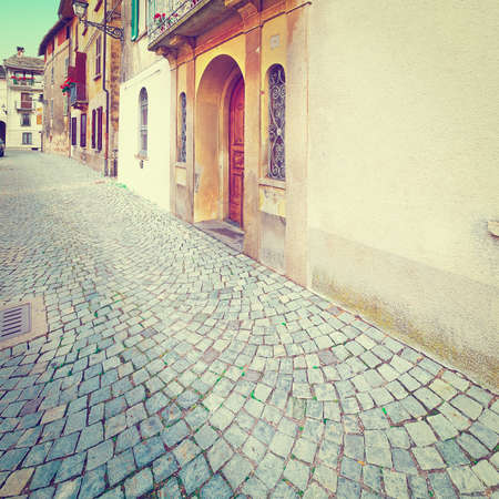 Narrow Street with Old Buildings in Italian City in Piedmont,の写真素材