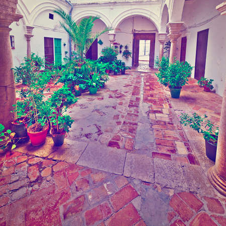 Patio in the Spanish House Decorated with Flowers, Vintage Style Toned Pictureの写真素材