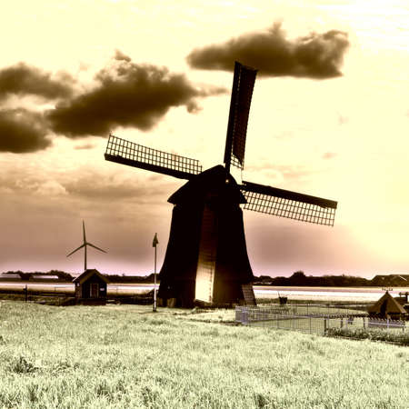 Landscape with Old Dutch Windmill at Sunset, Vintage Style Toned Picturの写真素材
