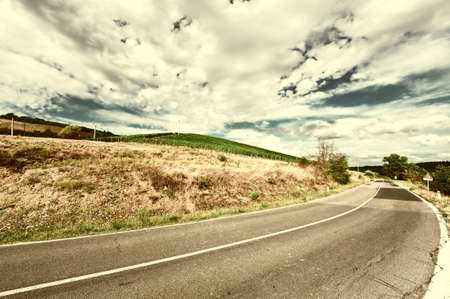 Winding Paved Road in the Tuscany, Italy, Vintage Style Toned Pictureの写真素材
