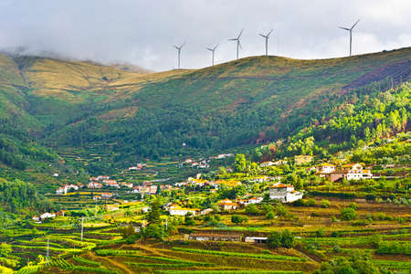 Modern Wind Turbines Producing Energy over the Vineyards in Portugalの写真素材