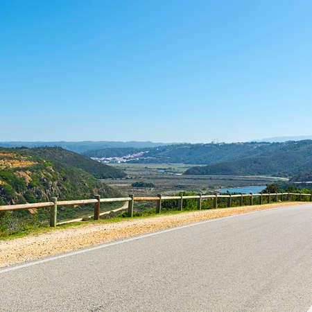 Asphalt Road between Hills Covered with Forest in Portugalの写真素材