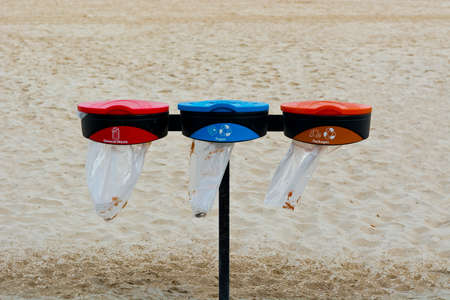 Blue and Red Recycling Containers on the Beach of Tel Aviv. Garbage Collectors Recycling Waste.の写真素材