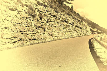 winding asphalt road in the french alps stylized photoの写真素材