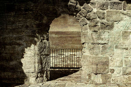 the city beach located adjacent to the sea walls of akko in israel view on a fortification of an old city akko a small israeli port town with ruins dating 4000 years vintage style toned pictureの写真素材