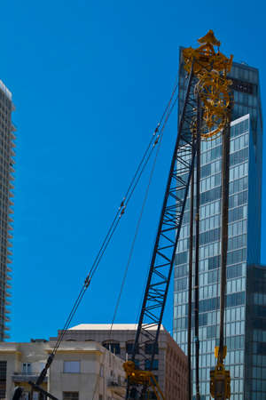crane and building under construction in tel-aviv industrial construction crane in israelの写真素材