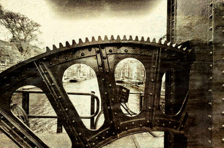 Detail of the lifting gear of drawbridge over the canal in Amsterdam. Street View with bikes, boats...