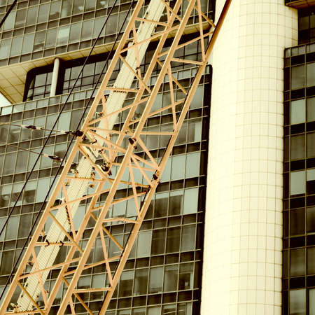 Crane and building under construction in Tel-Aviv. Industrial construction crane in Israel. Vintage...