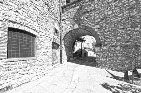 Narrow passage between old houses in Italy. Street with archway in the medieval italian town. Black and white pictureの写真素材