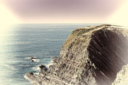 Rocky Coast of Atlantic Ocean in Portugal at Sunset, Stylized Photoの写真素材