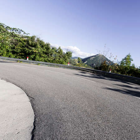 Mountain road between forests in Alpes-de-Haute-Provence department in southeastern France.の写真素材