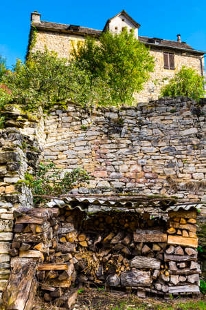Sawed firewood dropped in a pile in the medieval city of Auxillac in France. Auxillac is a commune...