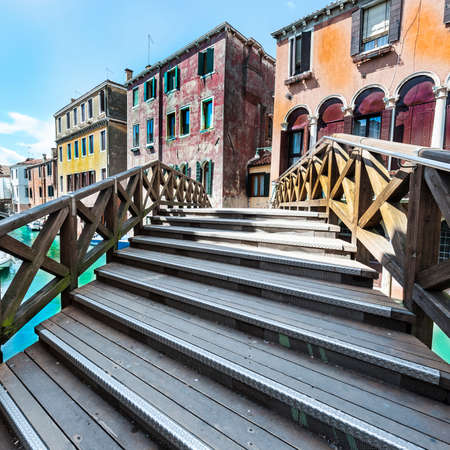 Houses peeling off from dampness. Venice is situated across a group of islands that are separated by canals and linked by bridges. Gondola is a traditional, flat-bottomed Venetian rowing boatの写真素材