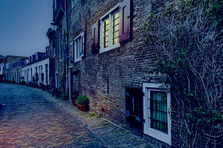 Typical Dutch brick houses in Holland at night. Street View with bikes parked in the historical center of Amersfoort in the Netherlandsの写真素材