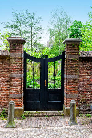 Entrance to the courtyard in traditional Dutch style. Path through the door in Holland city of Amersfoortの写真素材