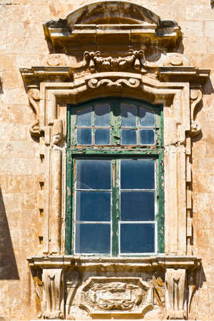 Building with traditional maltese window in historical part of Valletta.の写真素材