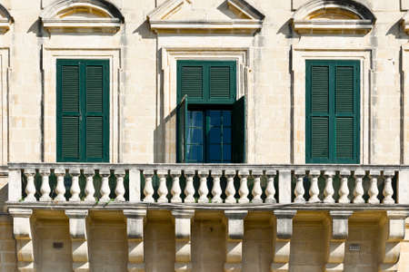 Building with traditional maltese windows in historical part of Valletta.の写真素材