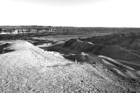 Rocky hills of the Negev Desert in Israel. Breathtaking landscape of the desert rock formations in the Southern Israel Desert. Black and white pictureの写真素材