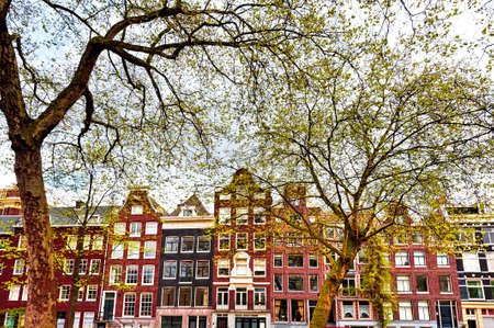 Historic buildings in the city of Amsterdam. Typical Dutch brick houses in Holland.の写真素材