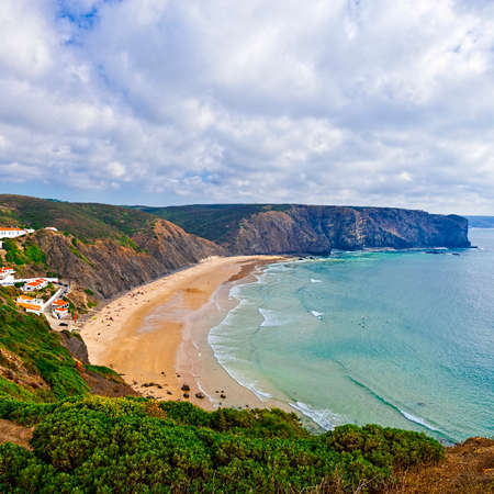 Sandy Beach on the Rocky Coast of Atlantic Ocean in Portugalの写真素材
