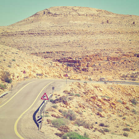 Winding Asphalt Road in the Negev Desert in Israelの写真素材