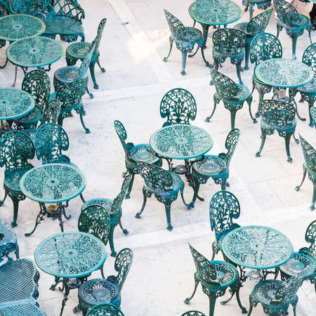 Openwork chairs and tables in a street cafe on Maltaの写真素材