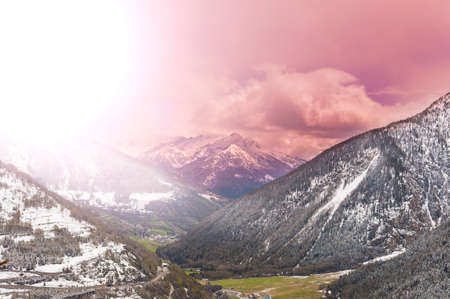 Morning mist in Italian Alps. View of the mountain forest valley at sunriseの写真素材