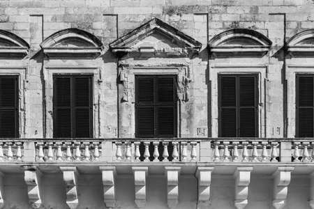 Building with traditional maltese windows in historical part of Valletta. Black and white pictureの写真素材