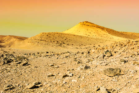 Rocky hills of the Negev Desert in Israel at sunrise. Breathtaking landscape of the desert rock formations in the Southern Israel Desert.の写真素材